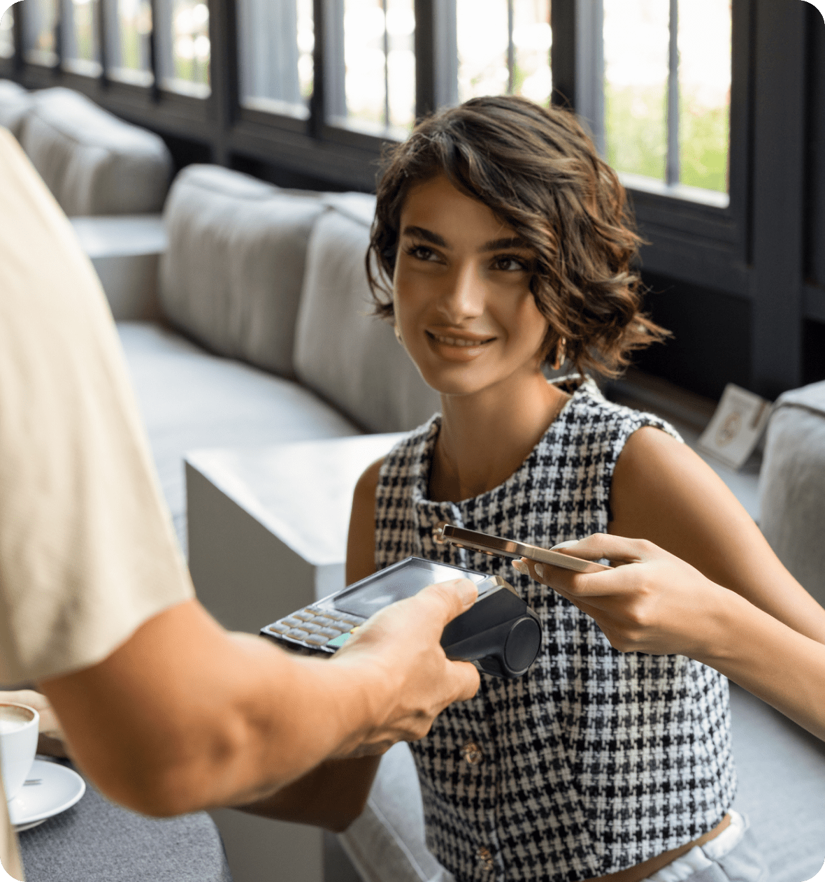 Woman paying with smartphone at cafe2.
