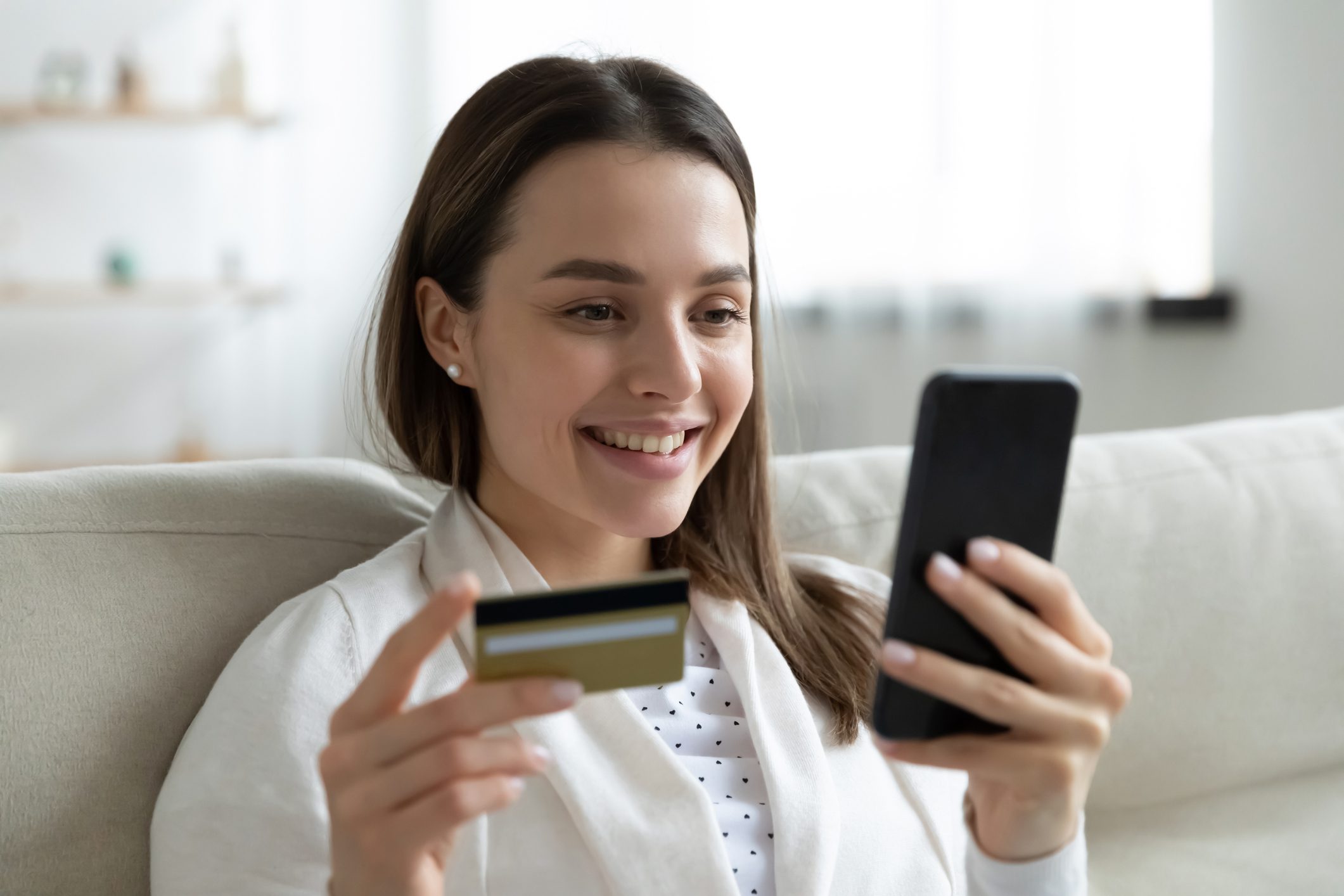 Woman shopping online with credit card.