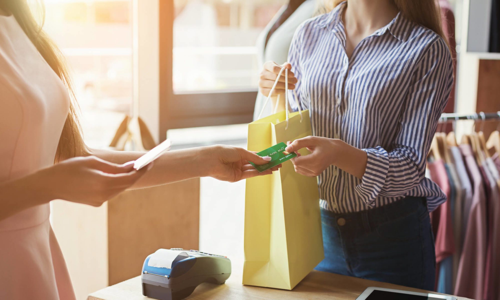 Customer paying with card at store counter.
