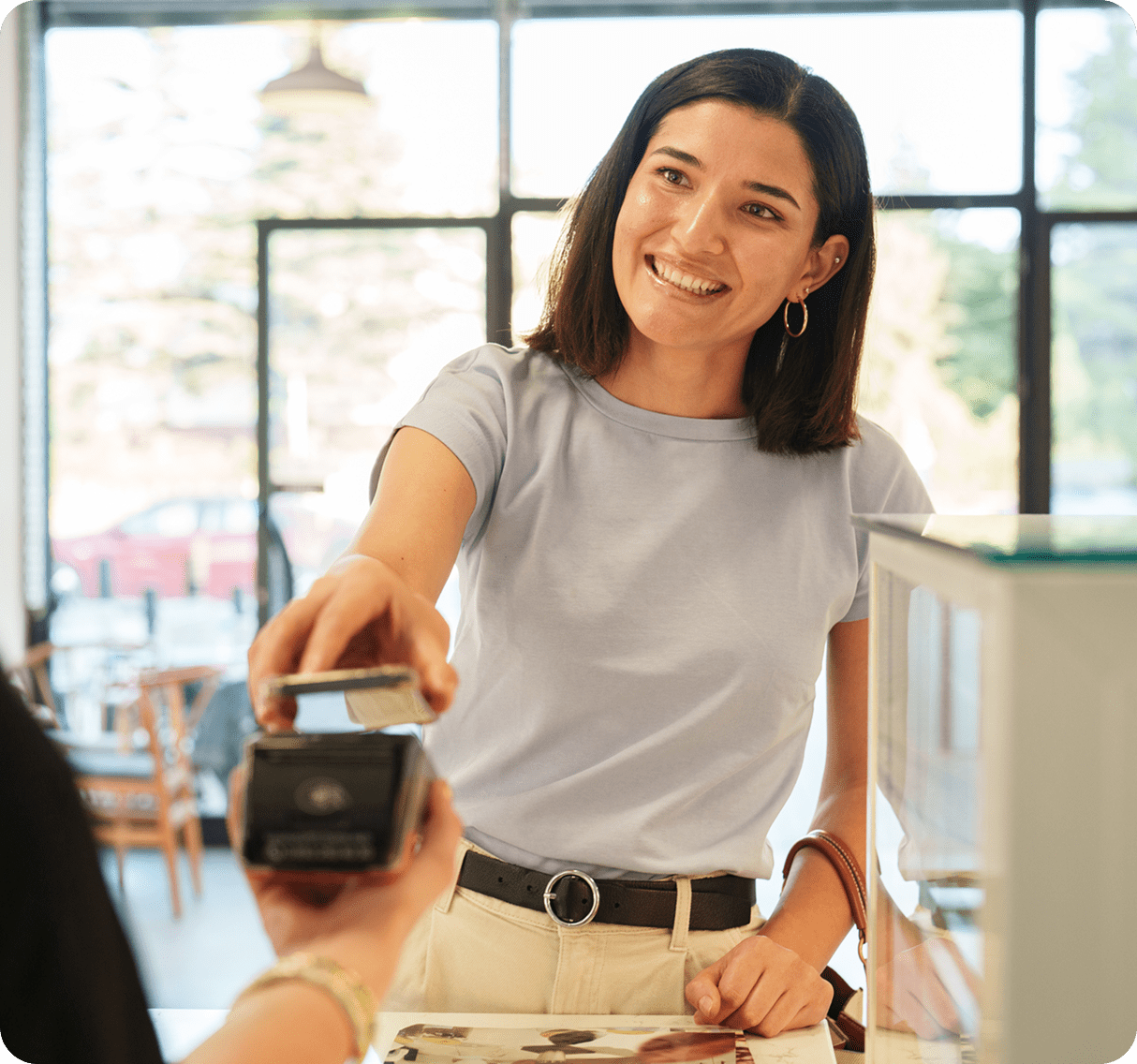 Smiling woman paying with credit card.
