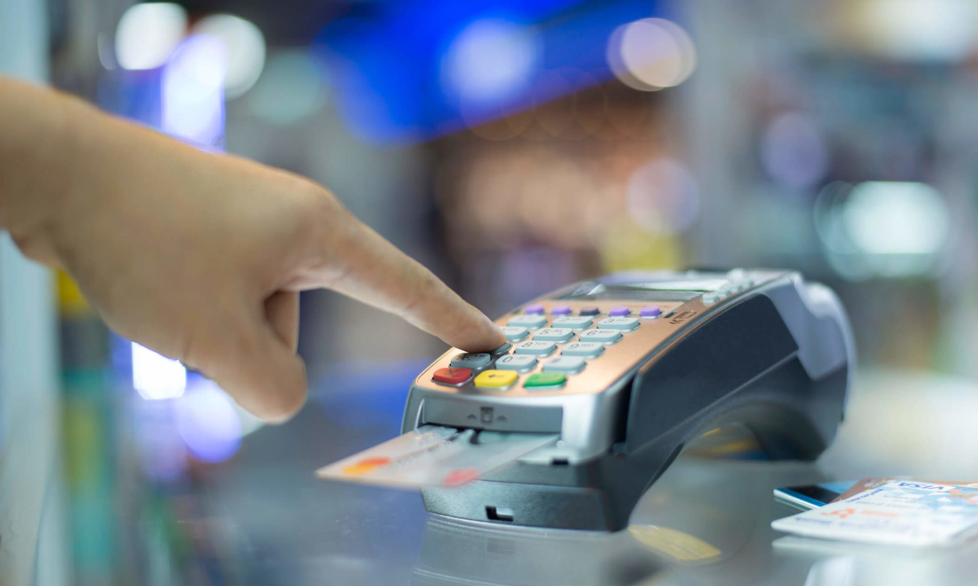 Hand using credit card payment terminal.